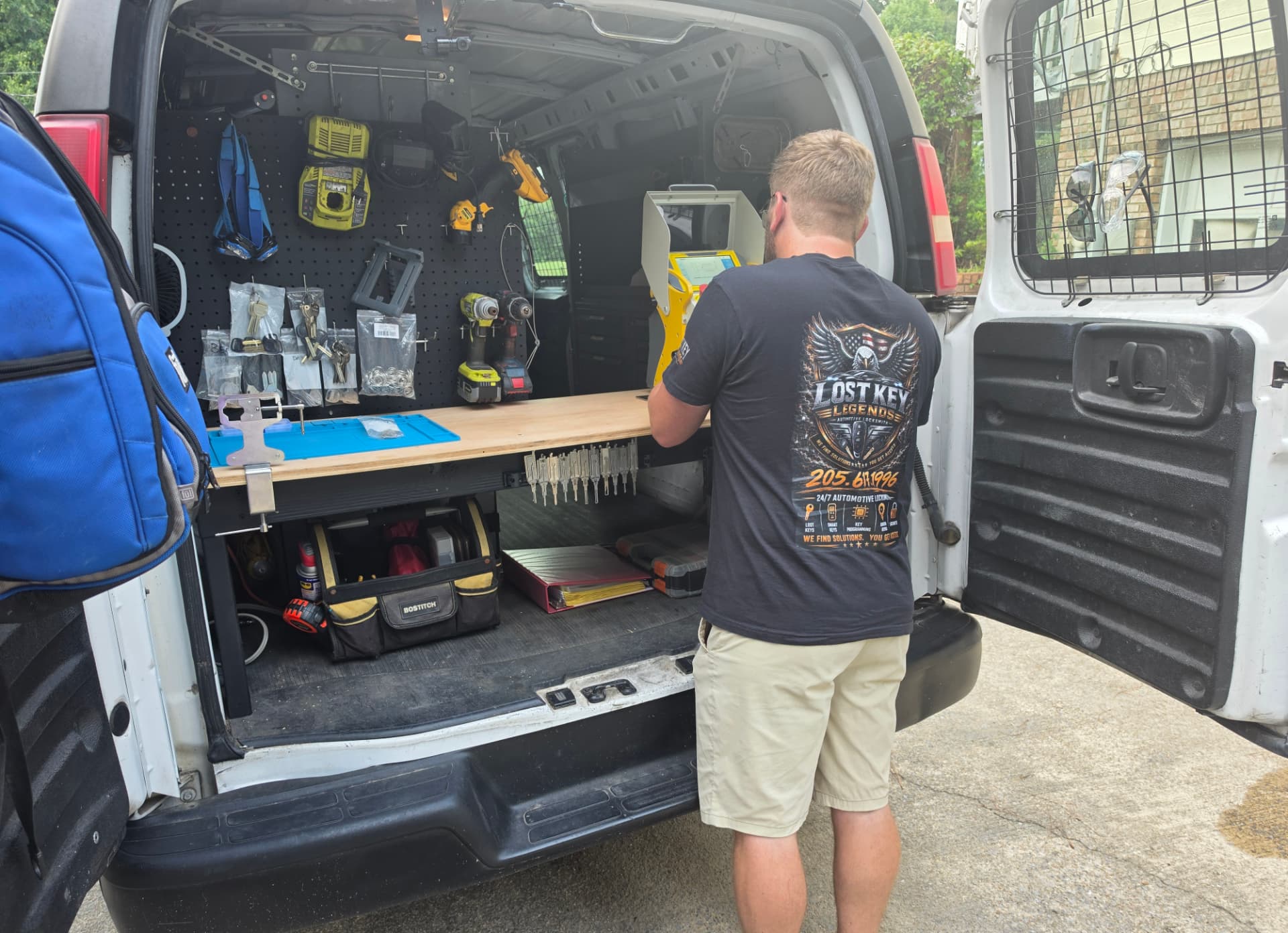Lost Key Legends locksmith cutting a car key in the mobile van in Moody Alabama